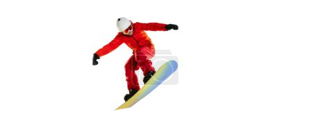 Foto de Portrait of active man, snowboarder in uniform riding on snowboard isolated over white studio background. Banner, flyer. Concept of winter sport, action, motion, hobby, leisure time - Imagen libre de derechos