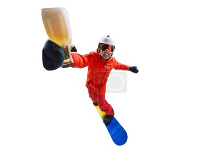 Foto de Portrait of active man, snowboarder in uniform riding on snowboard and holding beer glass isolated over white studio background. Concept of winter sport, action, motion, hobby, leisure time - Imagen libre de derechos