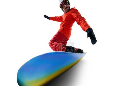 Photo for Lifestyle. Portrait of active man, snowboarder in uniform riding on snowboard isolated over white studio background. Concept of winter sport, action, motion, hobby, leisure time - Royalty Free Image