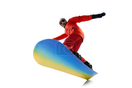 Photo for Bottom view. Portrait of active man, snowboarder in uniform riding on snowboard isolated over white studio background. Concept of winter sport, action, motion, hobby, leisure time - Royalty Free Image