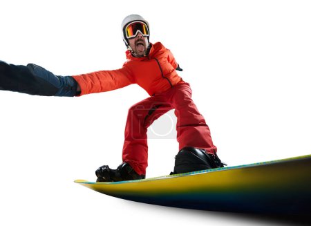 Foto de Positive vibes. Portrait of active man, snowboarder in uniform riding on snowboard isolated over white studio background. Concept of winter sport, action, motion, hobby, leisure time - Imagen libre de derechos