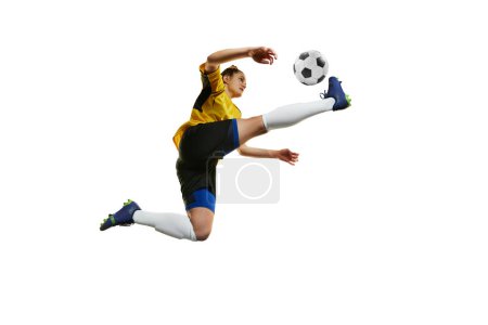 Foto de Kicking ball in a jump. Young professional female football, soccer player in motion, training, playing isolated over white background. Concept of sport, action, motion, goals, competition, hobby, ad. - Imagen libre de derechos