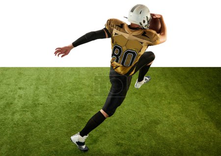 Foto de Man, professional american football player in motion, training, running with ball over white studio background with green grass flooring. Concept of sport, movement, achievements, competition, hobby - Imagen libre de derechos