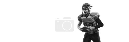 Photo for Black and white photo. Man, american football player in uniform posing with ball over white studio background. Concept of sport, movement, achievements, competition. Copy space for ad. Banner, flyer - Royalty Free Image