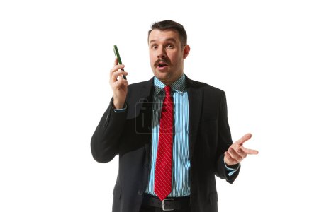 Foto de Businessman in a suit talking on phone over white studio background. New ideas, cooperations and partnership. Concept of business, career development, ambitions, innovative strategy. Copy space for ad - Imagen libre de derechos