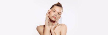 Foto de Tender, young, beautiful girl with perfect well-kept skin over white background. Taking care after skin with natural cosmetics. Concept of cosmetology, plastic surgery, natural beauty. Banner, flyer. - Imagen libre de derechos