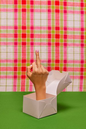 Photo for Pop art photography. Female hand sticking out food box and showing rude gesture with middle finger over retro background. Creativity, art. Complementary colors. Copy space for ad, text - Royalty Free Image