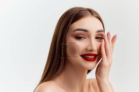 Photo for Tender make-up look. Young beautiful brunette girl with red lips makeup posing over grey studio background. Concept of natural beauty, youth, fashion, cosmetology, wellness, makeup. - Royalty Free Image