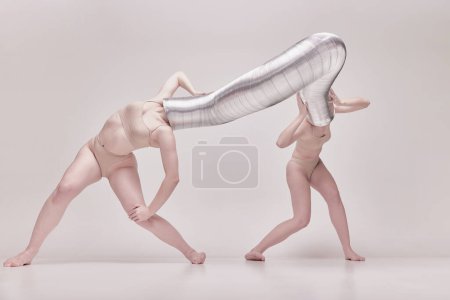 Photo for Illusion. Creative photography with two young girls posing in nude underwear over beige studio background. Concept of cringe, queer, art photography, weird people, creativity - Royalty Free Image