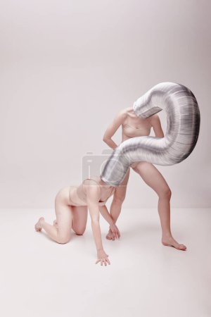 Photo for Futuristic photos. Creative photography with two young girls posing in nude underwear over beige studio background. Concept of cringe, queer, art photography, weird people, creativity - Royalty Free Image