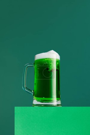Photo for Anise taste. Mug with foamy green beer isolated over green background. Degustation, festival. Concept of st patricks day celebration, brewery, traditions, alcohol drinks, taste, Irish holiday - Royalty Free Image