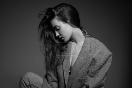 Foto de Black and white photography. Tenderness and sensuality. Beautiful young girl in stylish jacket. Modern fashion. Concept of beauty, fashion, youth, femininity, cosmetology, wellness - Imagen libre de derechos