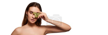 Photo for Young beautiful girl posing with body and massage tool - Gua sha on white studio background. Cerculation and lifting effect. Concept of natural beauty, youth, skincare, cosmetology, cosmetics. Banner - Royalty Free Image