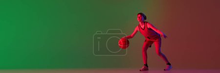 Photo for Teen girl, basketball player isolated over gradient green red background in neon light. Concept of sportive lifestyle, active hobby, health, competition. Banner. Copy space for ad, text - Royalty Free Image
