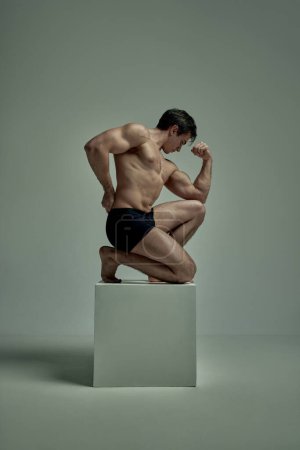 Photo for Masculinity. Handsome young man with muscular body posing shirtless in black underwear over studio background. Statue pose. Concept of mans beauty, sportive and healthy lifestyle, fashion - Royalty Free Image