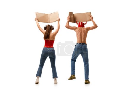 Photo for Back view image of young man and woman holding card with empty space for text over white background. Protest and demonstration. Concept of human rights, freedom and equality, political issues - Royalty Free Image