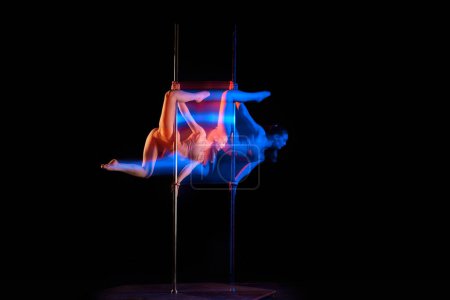 Photo for Sensual dancer. Young girl performing pole dance isolated over black studio background with mixed neon lights. Concept of sport and dance, beauty of movements, action, modern style - Royalty Free Image