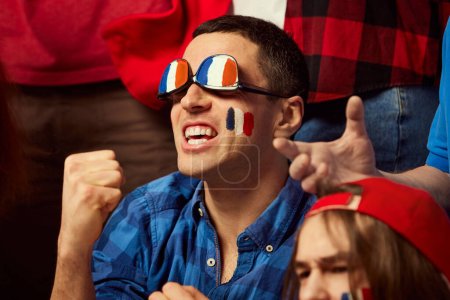 Photo for Football, soccer fans emotionally cheering up favourite france team. Man wearing glasses with countrys flag colors. Happy emotions, winning game. Sport, cup, world, team, event, competition concept - Royalty Free Image