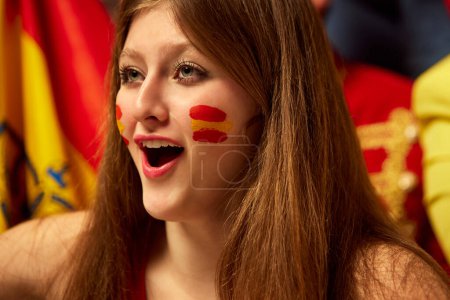 Photo for Close-up image of girl, football, soccer fans emotionally watching match, cheering up favourite team. Fans wearing colorful scarves and flags. Concept of sport, cup, world, team, event, competition - Royalty Free Image