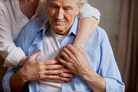 Foto de Imagen recortada de pareja jubilada encantadora, de mediana edad, anciana abrazando a su marido, dando amor y apoyo al hombre. Concepto de familia, relación, jubilación, estilo de vida, felicidad - Imagen libre de derechos