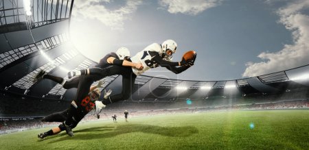 Photo for During game. American football players in action, catching ball at open air 3D stadium on daytime with spotlights. Championship. Concept of sport, competition, action and motion, game, world cup. - Royalty Free Image