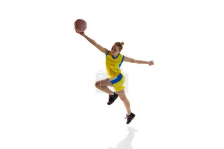 Photo for Young sportive girl in uniform, training with ball, playing basketball against white studio background. Isometric view. Concept of professional sport, hobby, healthy lifestyle, action and motion - Royalty Free Image