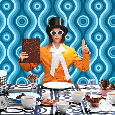 Photo for Making promise. Woman in image of literature character, in cylinder hat and sunglasses making vow with chocolate bar. Pattern blue background. Concept of pop art, creativity, food, inspiration - Royalty Free Image