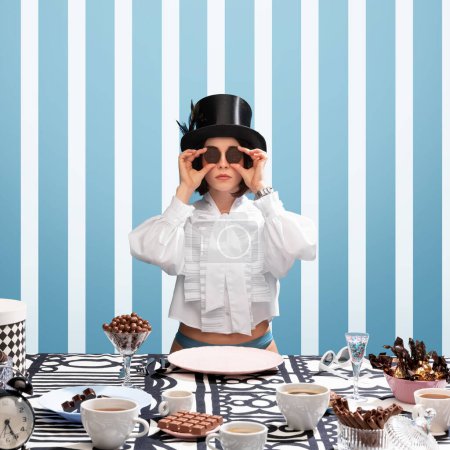 Photo for Stylish chocolate confectionery. Woman in white blouse and top hat holding chocolate biscuits on eyes. Striped, pattern blue background. Concept of pop art, creativity, food, inspiration - Royalty Free Image