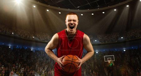 Photo for Young emotional man, professional basketball player in red uniform standing on 3D field and showing winning, positive emotions. Winning game. Concept of sport, competition, championship, emotions - Royalty Free Image