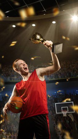 Photo for Vertical image of happy, excited young man, professional basketball player in red uniform holding trophy and ball on 3D stadium with confetti. Concept of sport, competition, game, emotions, win - Royalty Free Image