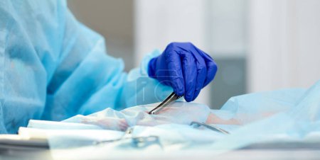 Photo for Close-up image of doctors hands in protective gloves, surgeon leading operation, working with surgery tools, instruments. Concept of medicine, hospital, healthcare, treatment, profession - Royalty Free Image