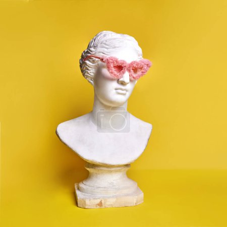 Photo for Antique statue bust wearing stylish, trendy, pink, fur sunglasses against yellow background. Beauty. Concept of creativity, modernity and vintage, antique art. Inspiration and imagination - Royalty Free Image