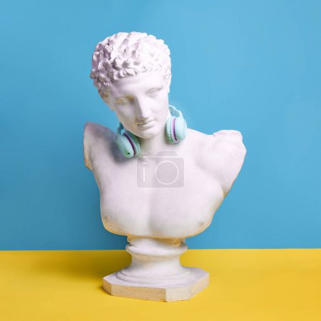 Photo for Antique statue bust wearing blue headphones against blue background. Music lifestyle, technologies, youth culture. Concept of creativity, modernity and vintage, antique art. Inspiration, imagination - Royalty Free Image