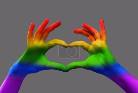 Photo for Human hands with rainbow light on it showing heart shape over grey background. Freedom of love, choice, support. Concept of freedom, lgbt, choice, human relation, community, togetherness, symbolism - Royalty Free Image