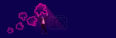 Businessman, employee holding neon colored puzzle icons symbolizing well-coordinated teamwork and professional assistance. Creative conceptual design. Concept of business, office, modern technologies