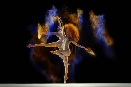 Photo for Artistic, colorful performance. Young man and woman, ballet dancers dancing with multi colored powder splashes against black background. Concept of art, festival, beauty of dance, inspiration, youth - Royalty Free Image