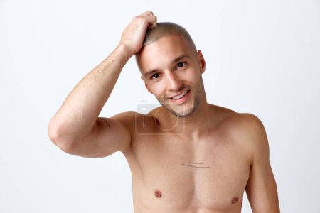 Photo for Well-being. Portrait of young attractive smiling man posing shirtless against white studio background. Perfect smile. Concept of mens beauty, skincare, cosmetology, spa, health. Copy space for ad - Royalty Free Image