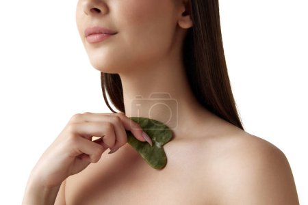 Photo for Cropped image of woman with well-kept healthy skin taking care after body with cosmetological massage tool over white background. Concept of natural female beauty, body and skincare, cosmetology, ad - Royalty Free Image