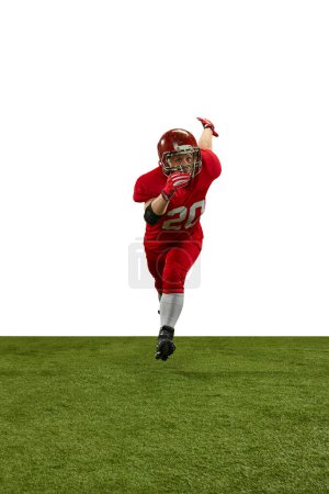 Photo for Front view dynamic image of man, american football player in red uniform running on field during game against white background. Professional sport, action, lifestyle, competition, training, ad concept - Royalty Free Image