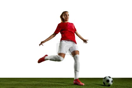 Photo for Young girl, female football player training, playing on sports field against white background. Game. Concept of professional sport, action, lifestyle, competition, hobby, training, ad - Royalty Free Image