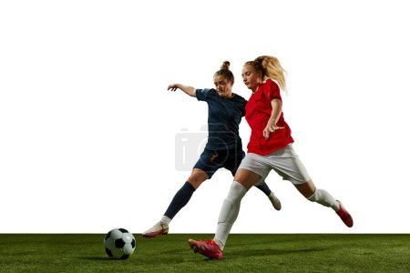 Photo for Two young girls, football players in motion, training, dribbling ball against white background. Sportschool. Concept of professional sport, action, lifestyle, competition and hobby, training, ad - Royalty Free Image