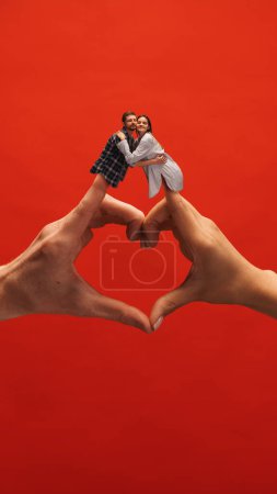 Foto de Collage creativo con las manos. Hermosa pareja joven, hombre y mujer abrazándose sobre el símbolo de la mano del corazón, mostrando amor y apoyo. Concepto de emociones, sentimientos, psicología, relación, comunicación, anuncio - Imagen libre de derechos