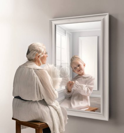 Photo for Creative conceptual collage. Senior lady, woman looking in mirror with reflection of little girl, child. Younger self. Memories. Concept of present, past and future, age, lifestyle, generation, ad - Royalty Free Image