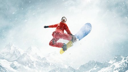 Photo for In motion. Flying high. Sportive man riding snowboard over snowy mountains background. Warm sunny day. Concept of winter sport, action, motion, hobby, leisure time. Banner. Copy space for ad - Royalty Free Image