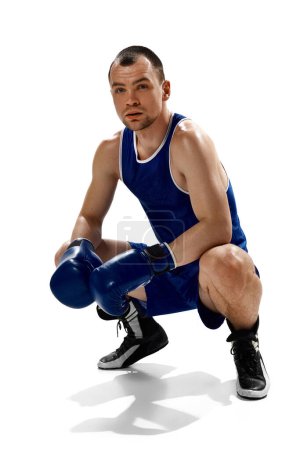 Photo for Portrait of young muscular, professional boxer posing in uniform isolated over white background. Concept of professional sport, action and motion, health., strength, competition, ad - Royalty Free Image