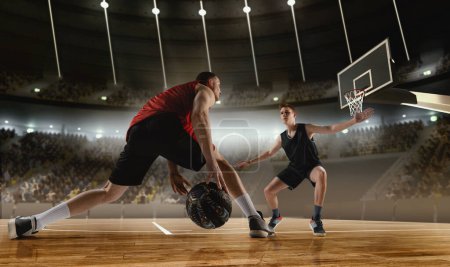 Photo for Competitive young men, basketball players in motion during match, game playing at 3D arena with flashlights. Scoring winning goal. Concept of professional sport, competition, action, hobby, game. - Royalty Free Image