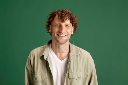 Photo for Happiness. Portrait of mature man with curly hair, in casual clothes posing with smile against green studio background. Concept of human emotions, facial expression, lifestyle, fashion, ad - Royalty Free Image