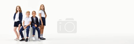 Photo for Group of beautiful children, boys and girls in stylish school clothes, uniform against white studio background. Concept of childhood, school, education, fashion, style. Copy space for ad. Banner - Royalty Free Image