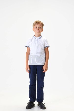 Photo for Full-length portrait of boy, child wearing smart casual clothes for school, standing against white studio background. Concept of childhood, school, education, fashion, style. Copy space for ad - Royalty Free Image