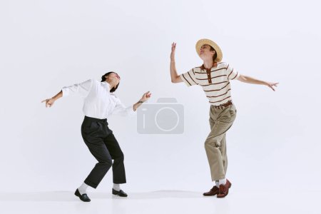 Photo for Artistic, talented young people, man and woman in stylish retro clothes dancing isolated on white studio background. Concept of art, hobby, retro dance style, choreography, beauty. Ad - Royalty Free Image